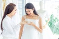 Young asian bride looks pearl necklace on her bridesmaid hands in Wedding Dress Shop prepare for wedding ceremony Ã Â¸Â£Ã Â¸Â· Wedding Royalty Free Stock Photo